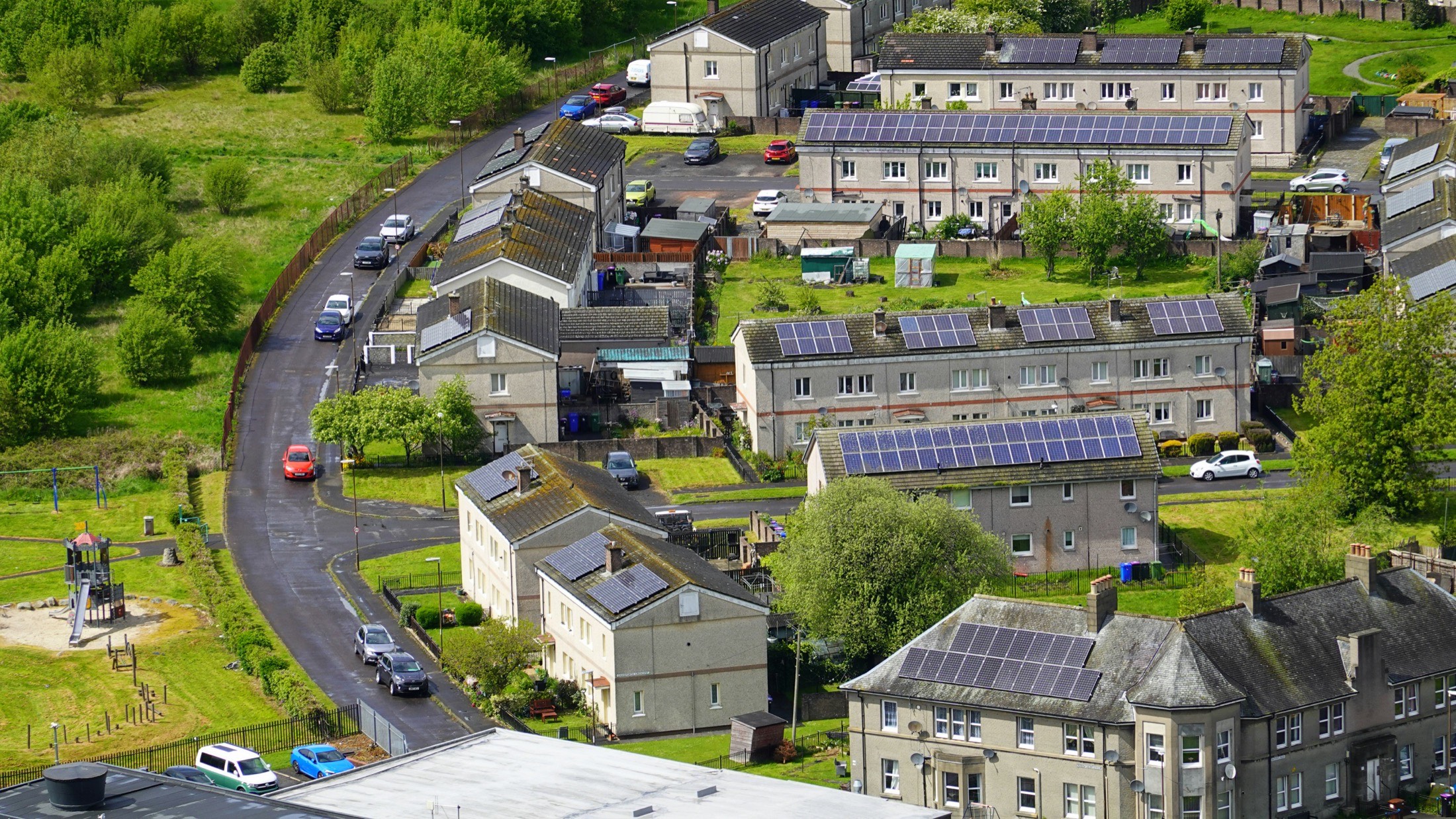 Rooftop solar panels installed across a residential neighborhood.